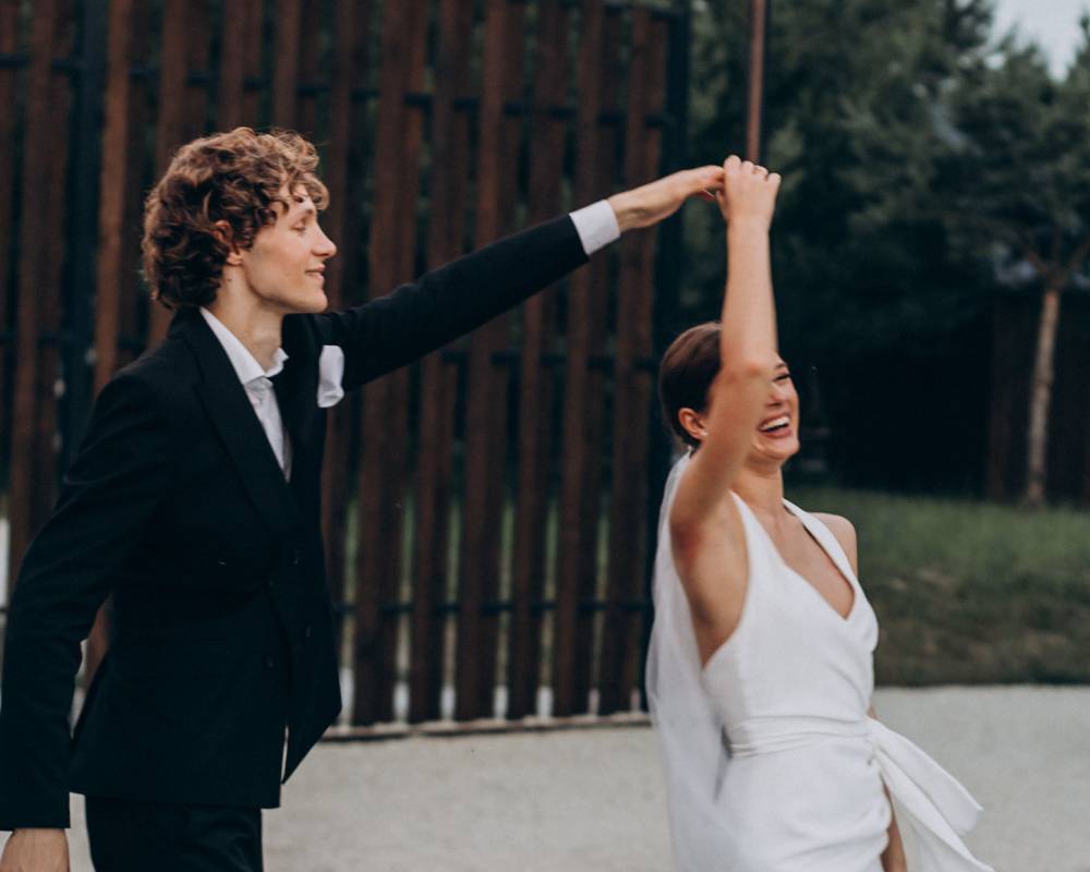 Young wedding couple dancing together on their own